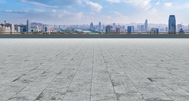 Empty brick floor with city skyline background