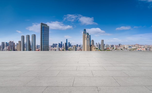 Empty brick floor with city skyline background