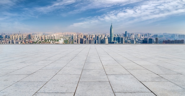 Empty brick floor with city skyline background