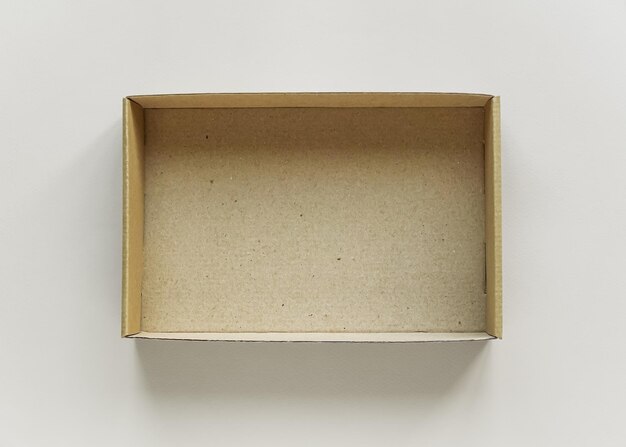 empty brown cardboard box on gray background