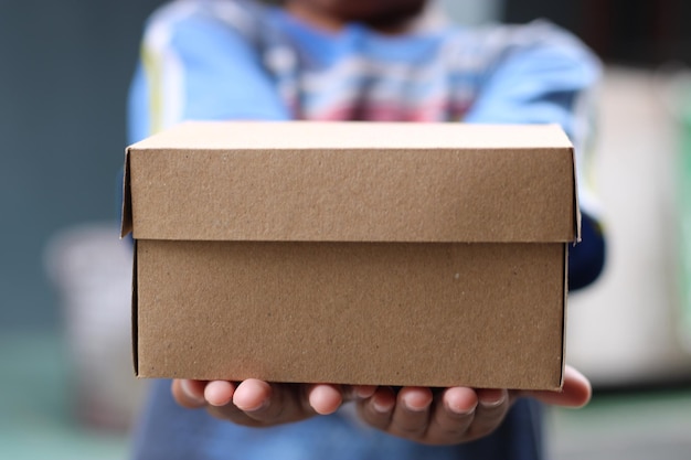 Empty brown cardboard photo held in hand