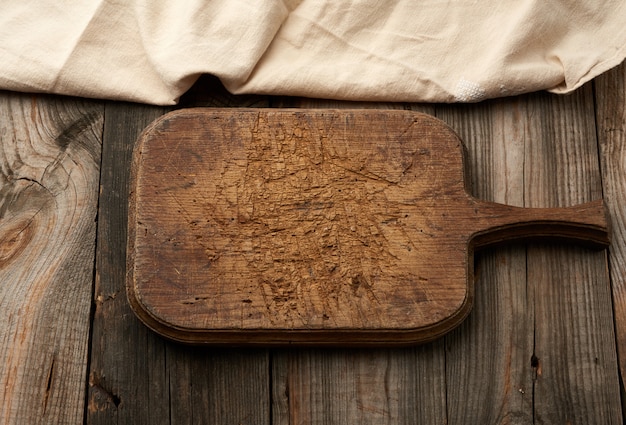 Empty brown very old vintage kitchen cutting board with handle