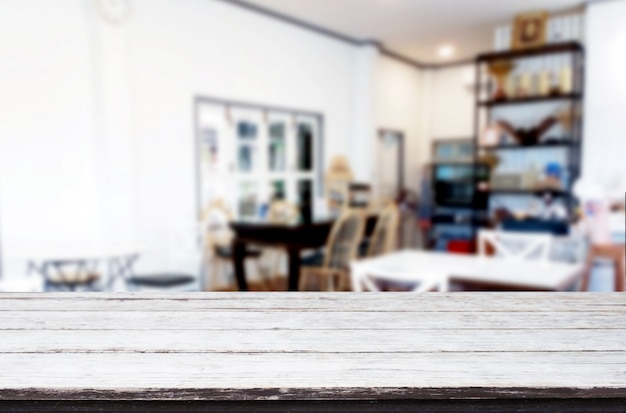 empty brown wooden table and Coffee shop or restaurant blur background 