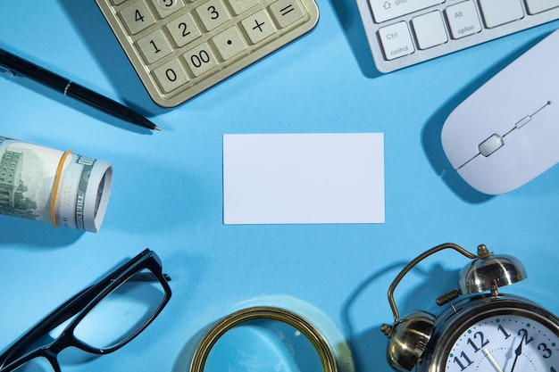 Empty business card and business objects on the blue background