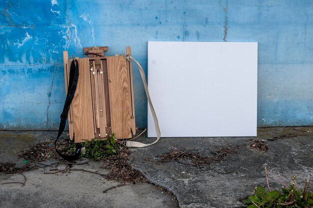 Empty canvas in front of weathered wall