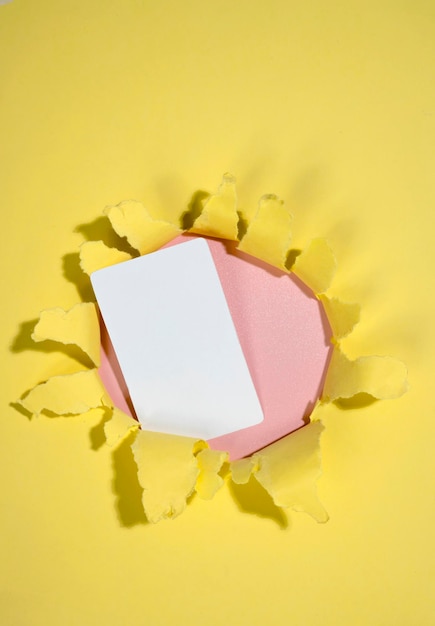 empty card on the hole of ripped paper mockup or copy space template greetings or business card concept of message or communication