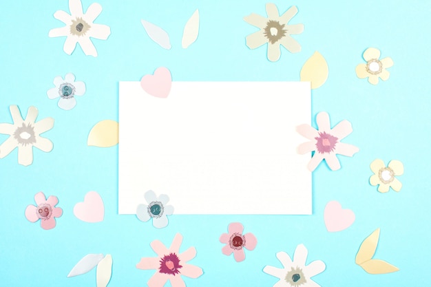 Empty card with spring, easter decoration over blue pastel backgroung