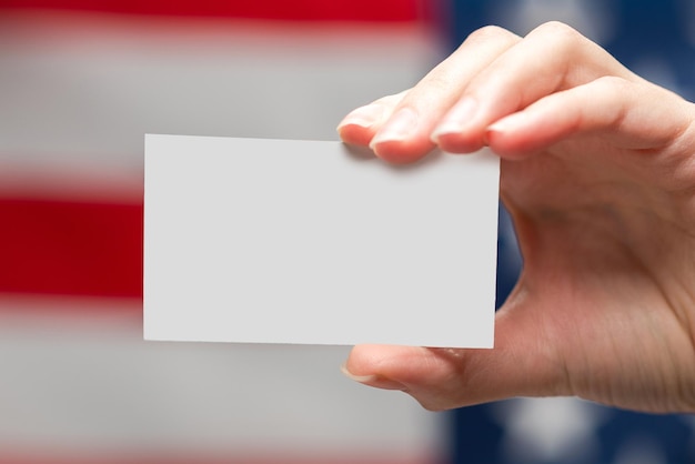 Empty card in woman hand Copy space American flag background