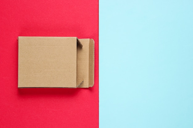 Empty cardboard box on color paper