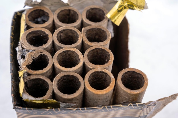 Empty cardboard casings of burnt fireworks in a box after the explosion at the festival Spent