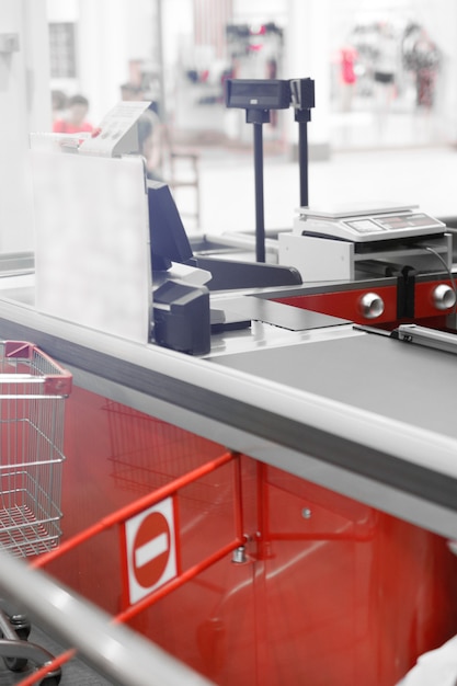 Empty cash desk with closed way border in supermarket.