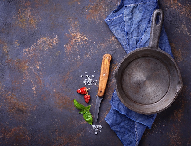 Empty cast iron fried pan with herbs and spices