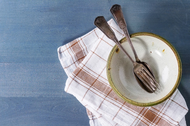 Empty ceramic bowl and cutlery