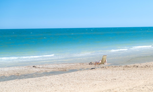 Empty chair on the beach beach with blue sky and sea as vacation concept