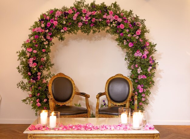 empty chairs by pink flower decorations