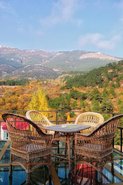 Empty chairs and table arranged at restaurant against mountains