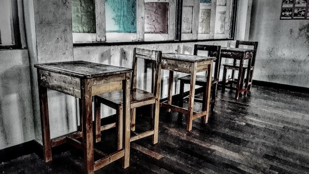 Empty chairs and table in classroom