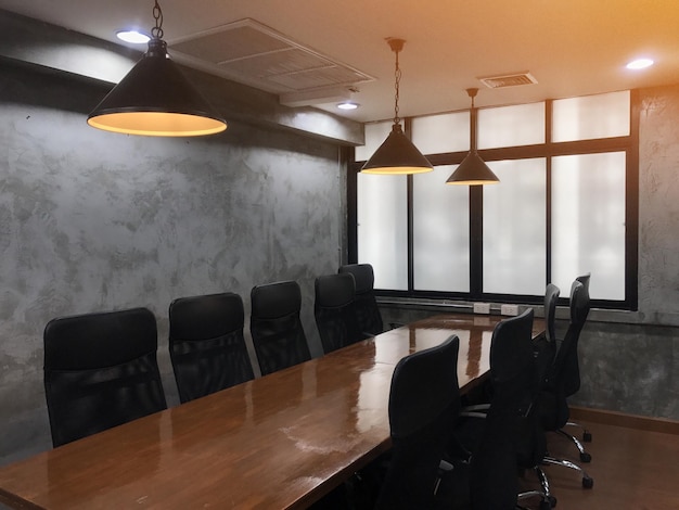 Empty chairs and tables arranged in conference room