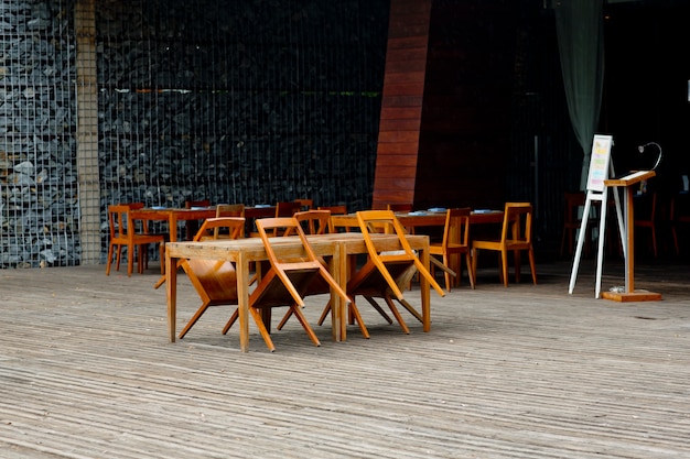 Empty chairs and tables at closed outdoor restaurant