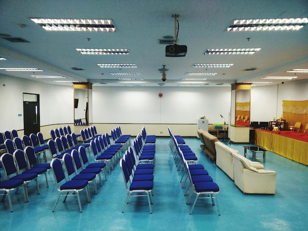 Empty chairs and tables in row