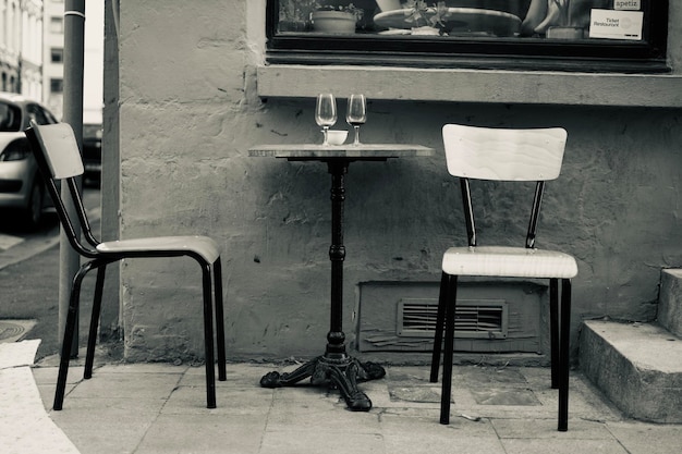 Empty chairs and tables on street