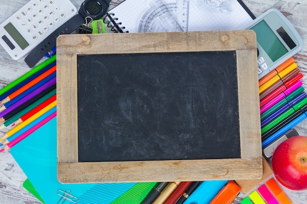 Empty Chalkboard with copy space and school supplies