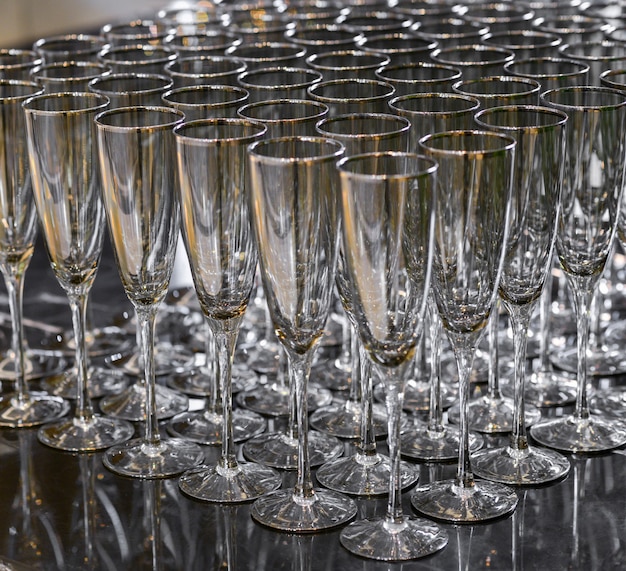 Empty champagne glasses standing in a row. many wine glasses for champagne