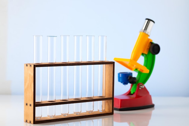 Photo empty chemical test tubes on a stand and a childrens microscope chemistry lessons at school