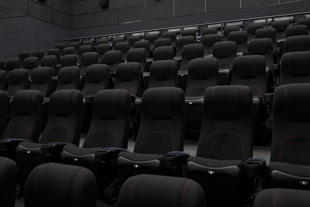 Empty cinema hall with black seats Movie theatre nobody