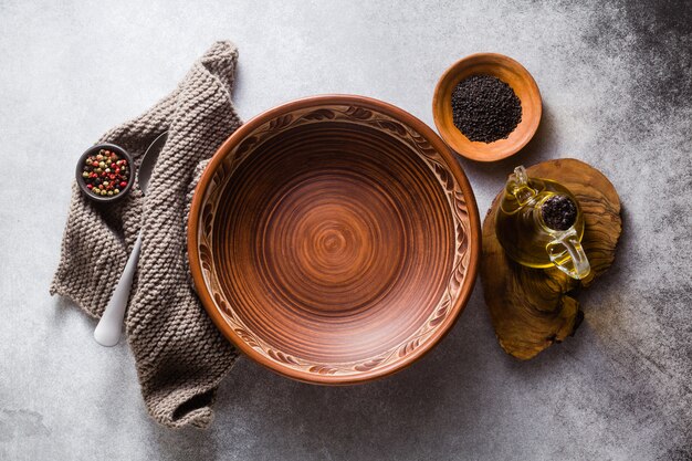 Empty clay plates on the table set for lunch or dinner.