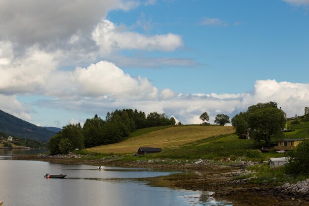 Empty coast of norwegian fjord at cloudy dayxA