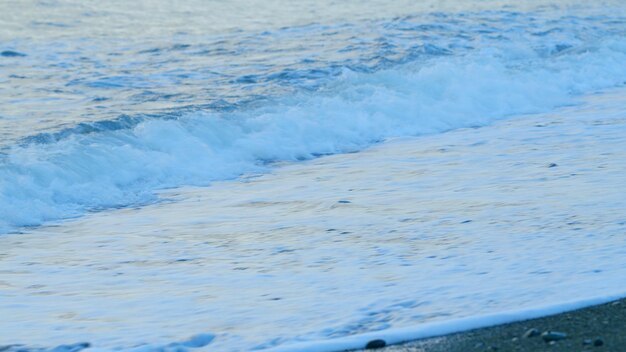 Empty coastline pebble beach ocean waves on beach nature and relaxation concept real time