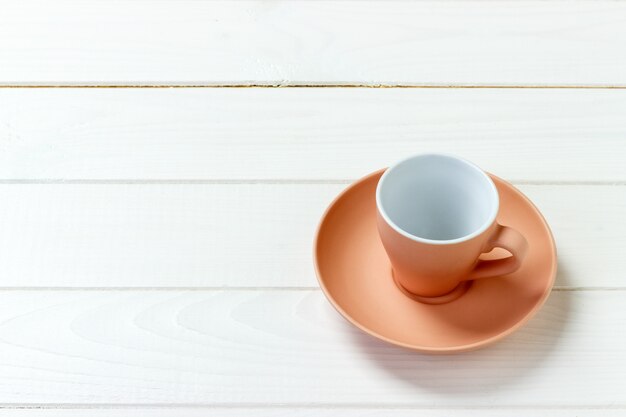 Empty colorful cup on plate for coffee or tea