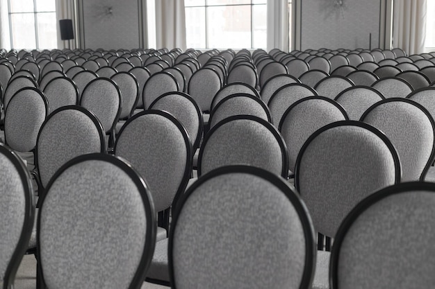 Empty conference hall Empty rows of grey chairs Monochrome