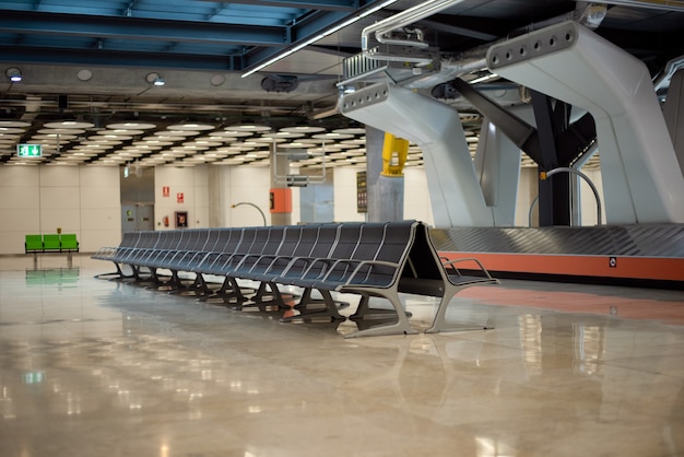 Empty conveyor luggage airport belt and sits