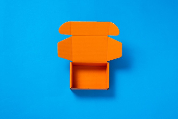 Empty coor cardboard box on blue background