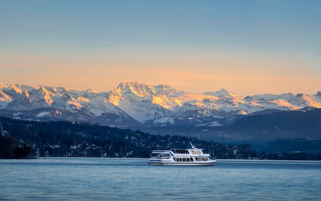 Empty cruise boat sailing on Zurich lake at sunset