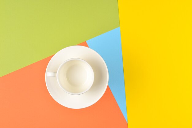 Empty cup on colorful background.