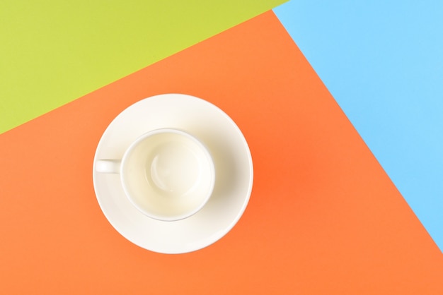 Empty cup on colorful background.