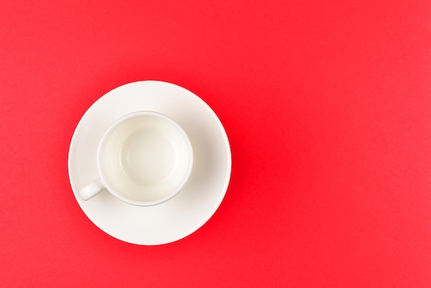 Empty cup on a red background