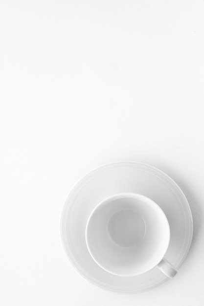 Empty cup and saucer mockup on white background flatlay