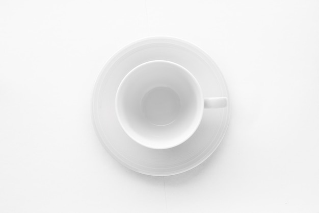 Empty cup and saucer mockup on white background flatlay