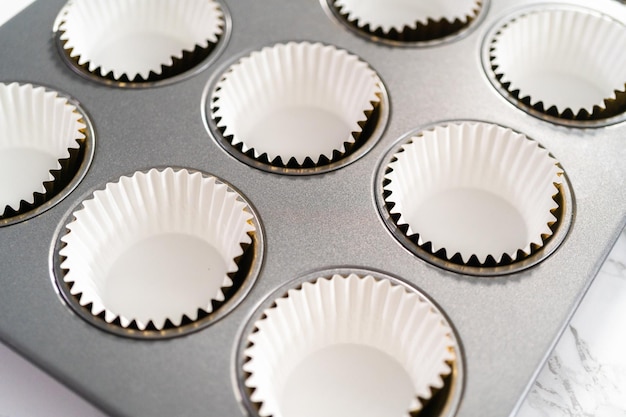 Empty cupcake liners in cupcake pan ready for baking.