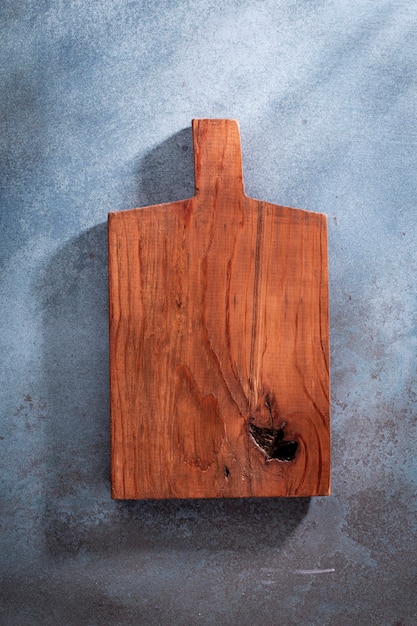 Empty cutting board on an old rustic table