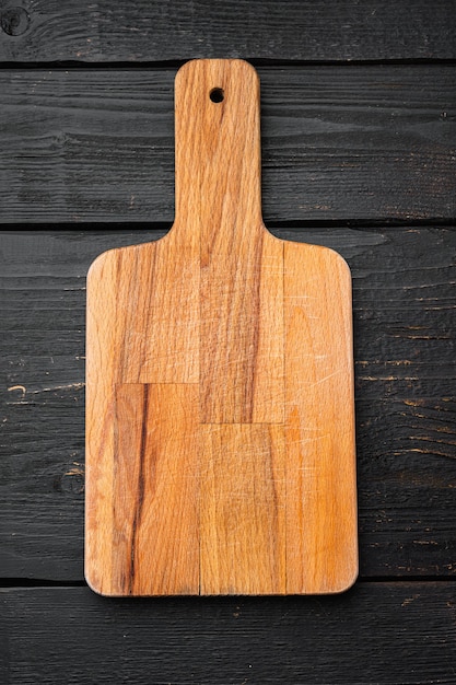 Empty cutting board set, on black wooden table background, top view flat lay , with copy space for text or your product