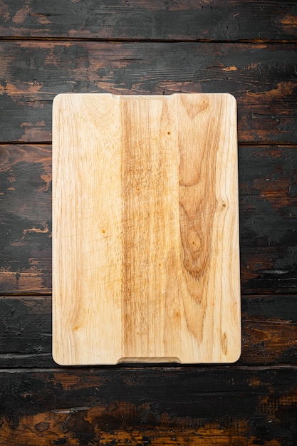 Photo empty cutting board set, on old dark  wooden table background, top view flat lay , with copy space for text or your product