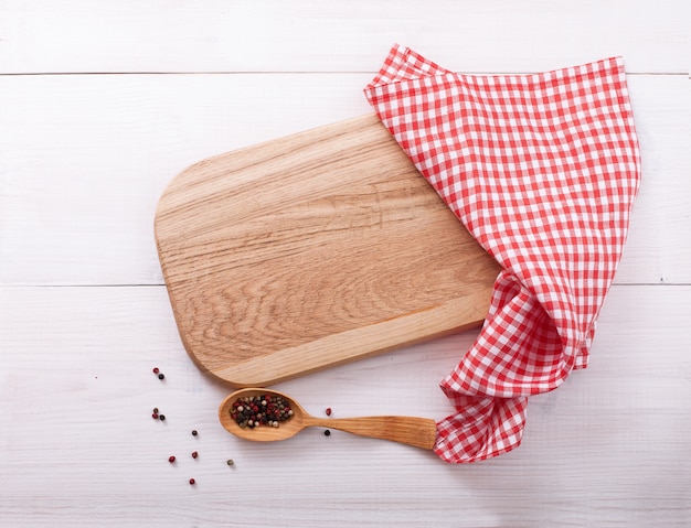 Empty cutting board with napkin on wooden table