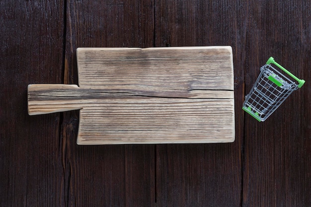 Empty cutting board on wooden brown background