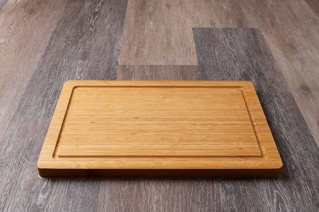 Empty cutting board on a wooden table