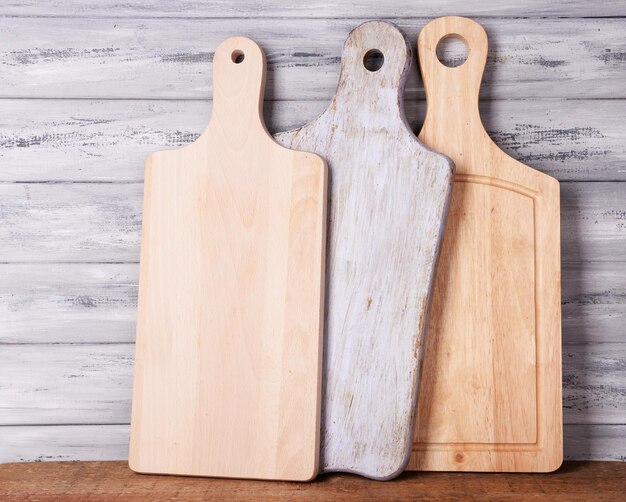 Empty cutting boards on wooden background